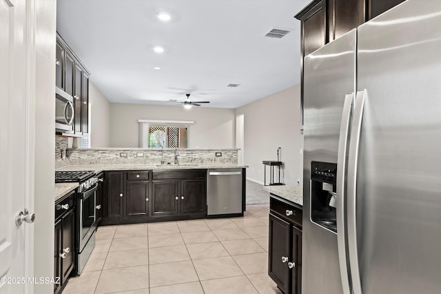 kitchen with a sink, stainless steel appliances, visible vents, and light tile patterned floors