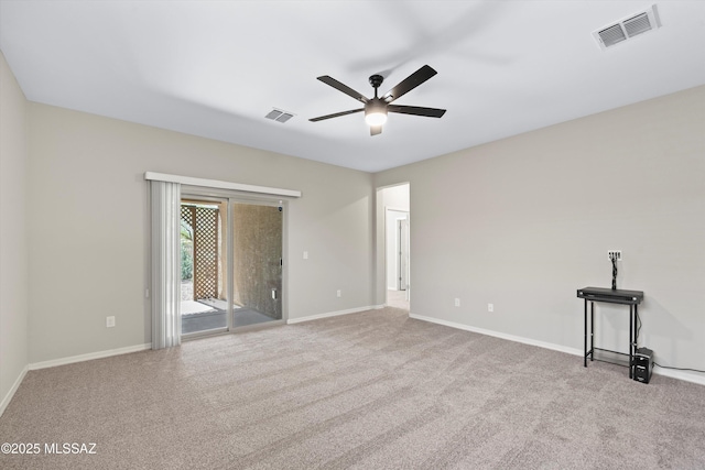 empty room with visible vents, baseboards, and carpet