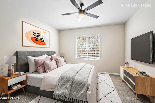 carpeted bedroom featuring baseboards and ceiling fan