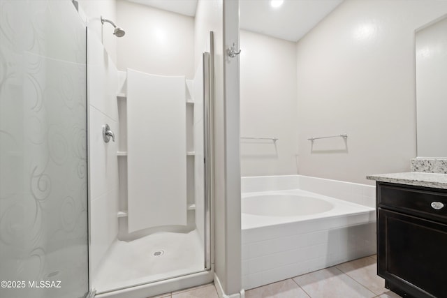 full bathroom with tile patterned flooring, a stall shower, vanity, and a bath