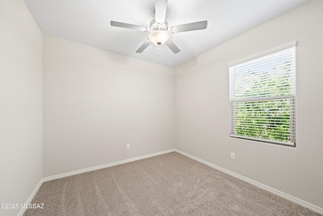 carpeted spare room with baseboards and ceiling fan