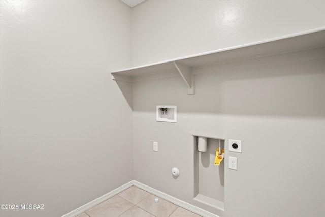 clothes washing area featuring washer hookup, hookup for a gas dryer, baseboards, hookup for an electric dryer, and laundry area