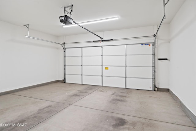 garage featuring baseboards and a garage door opener