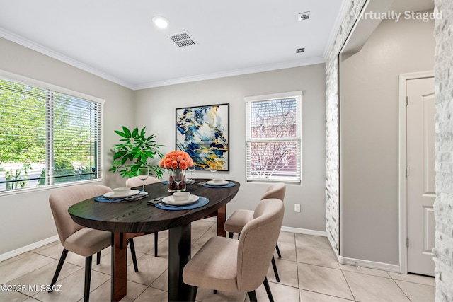 dining area with light tile patterned floors, visible vents, a healthy amount of sunlight, and ornamental molding