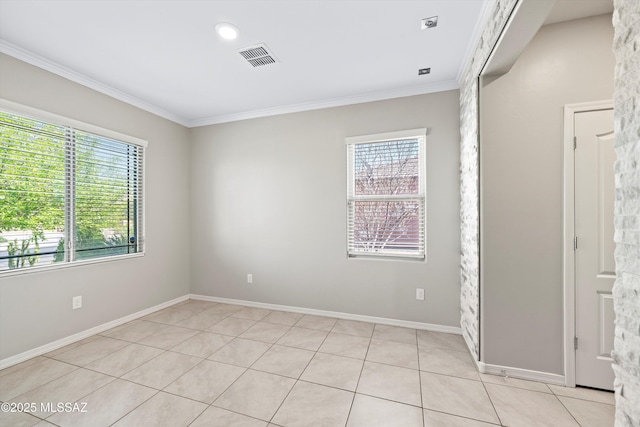 spare room with light tile patterned flooring, visible vents, baseboards, and ornamental molding