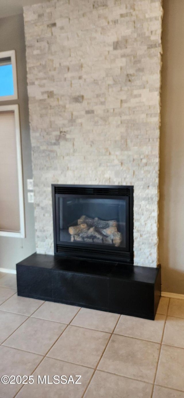 interior details with a fireplace and baseboards