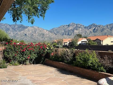 view of patio featuring fence and a mountain view