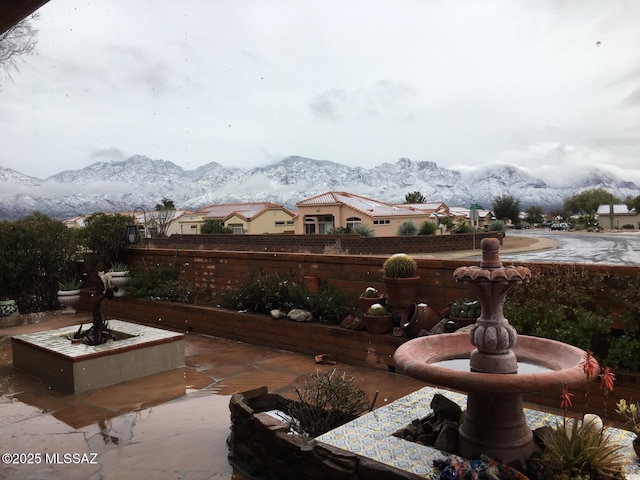 exterior space featuring a mountain view, a patio, and fence