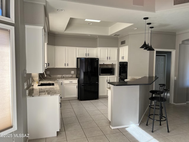 kitchen featuring visible vents, a raised ceiling, black appliances, a sink, and light tile patterned flooring