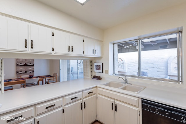 kitchen featuring a sink, white cabinetry, light countertops, and dishwasher