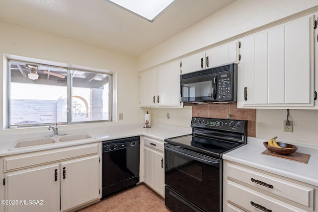 kitchen featuring light tile patterned floors, a sink, light countertops, black appliances, and tasteful backsplash