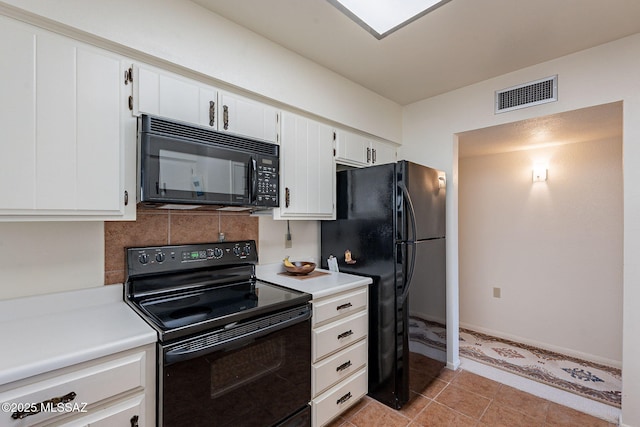 kitchen featuring black appliances, visible vents, light countertops, and decorative backsplash