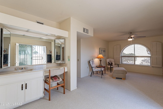 bathroom featuring vanity, visible vents, and a ceiling fan