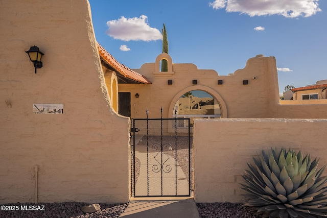 view of gate with fence