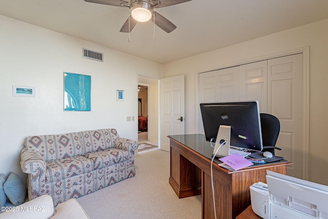 carpeted home office with ceiling fan and visible vents