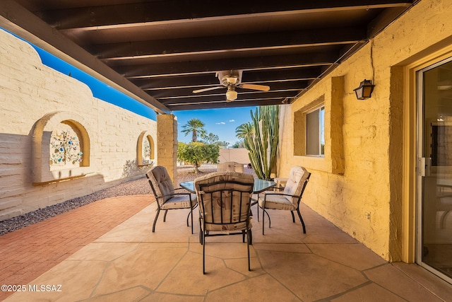 view of patio / terrace with outdoor dining space, fence, and a ceiling fan