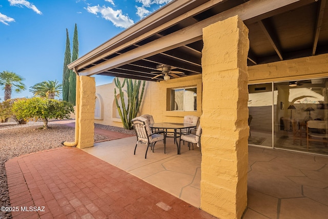 view of patio with outdoor dining area and ceiling fan