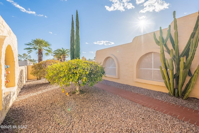 view of home's exterior featuring fence and stucco siding