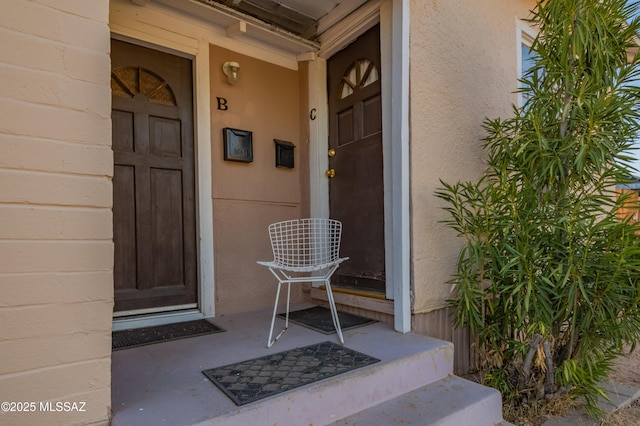 property entrance with stucco siding