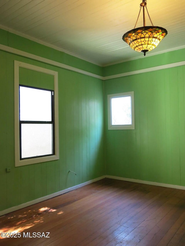 empty room featuring baseboards and hardwood / wood-style floors