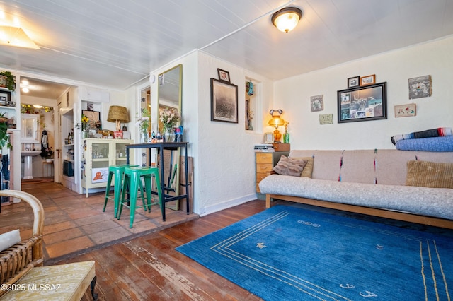 living area featuring hardwood / wood-style flooring and baseboards