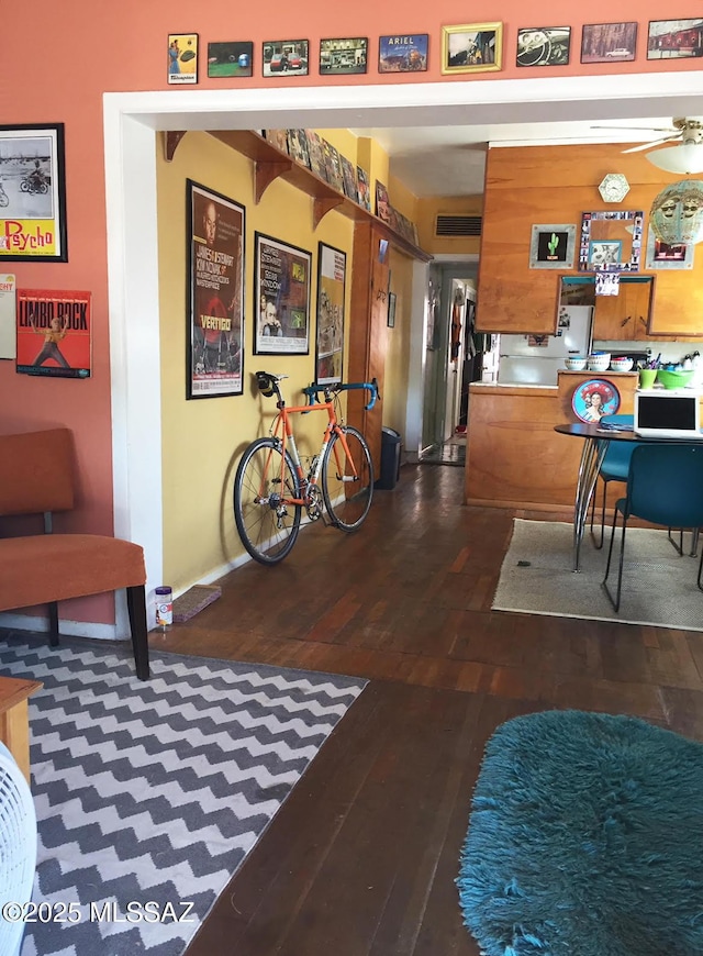 interior space featuring a ceiling fan and wood-type flooring