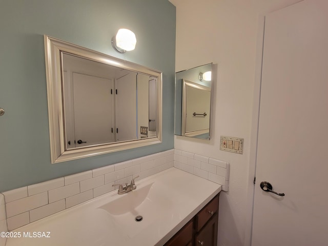 bathroom with vanity and tasteful backsplash