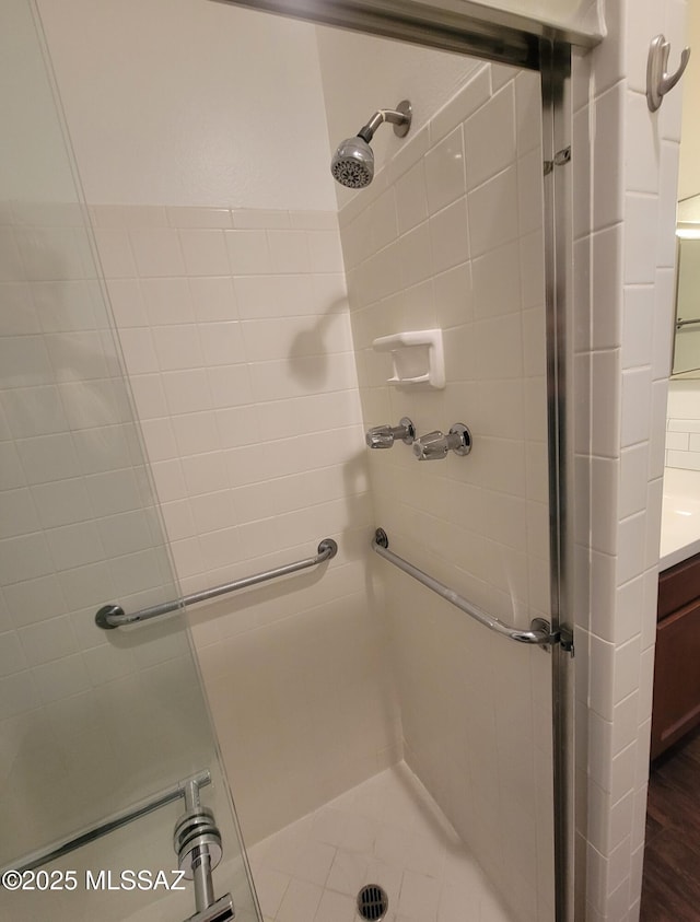 bathroom with vanity and a shower stall