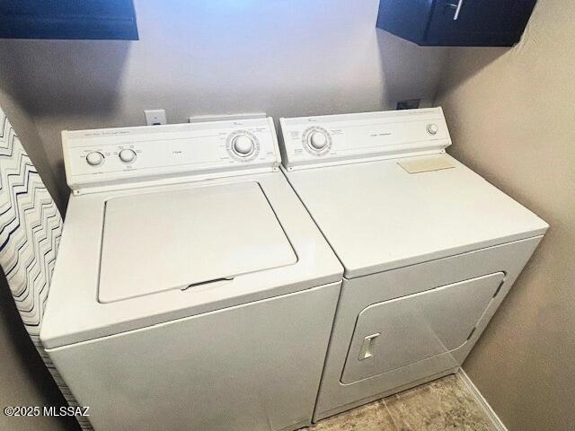 laundry area featuring washer and clothes dryer, laundry area, and baseboards