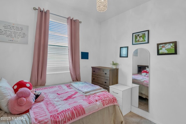 bedroom featuring light colored carpet and arched walkways