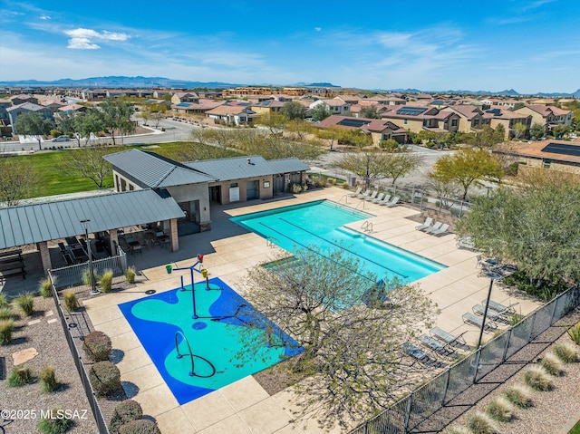 pool featuring a residential view, a patio, and fence