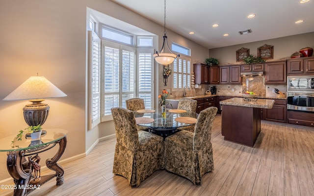 5084 W Desert Poppy Ln, Marana, AZ 85658 - dining room with light wood-type flooring, recessed lighting, baseboards, and visible vents