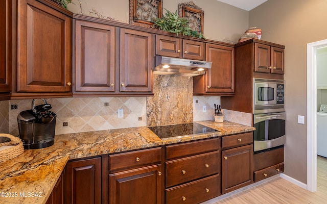 5084 W Desert Poppy Ln, Marana, AZ 85658 - kitchen with decorative backsplash, under cabinet range hood, light stone countertops, and stainless steel appliances