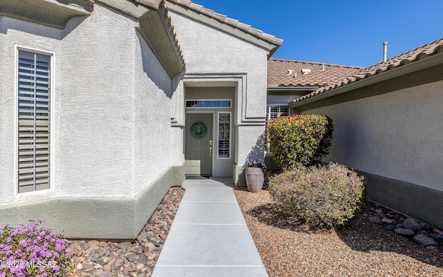 5084 W Desert Poppy Ln, Marana, AZ 85658 - property entrance featuring stucco siding and a tile roof