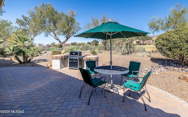 5084 W Desert Poppy Ln, Marana, AZ 85658 - view of patio with grilling area, outdoor dining area, and fence