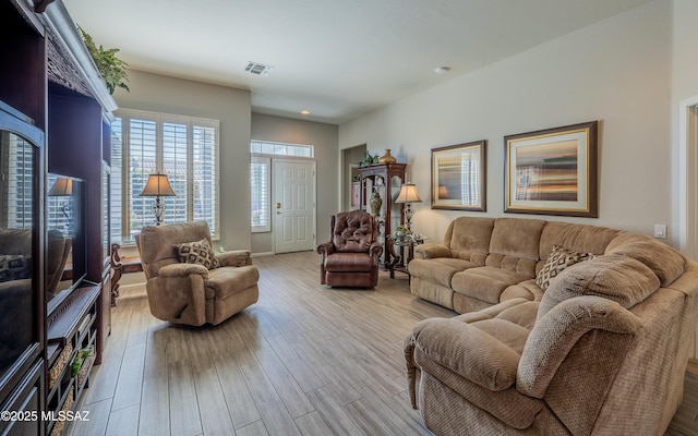 5084 W Desert Poppy Ln, Marana, AZ 85658 - living room featuring visible vents and wood finished floors