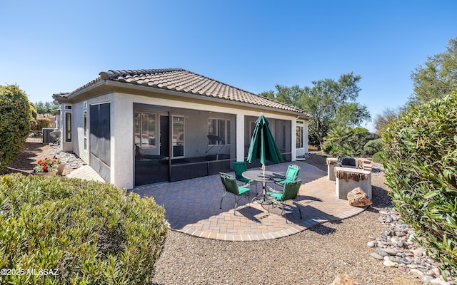 5084 W Desert Poppy Ln, Marana, AZ 85658 - rear view of house with a tile roof, a sunroom, stucco siding, and a patio
