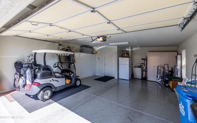 5084 W Desert Poppy Ln, Marana, AZ 85658 - garage with a garage door opener and freestanding refrigerator