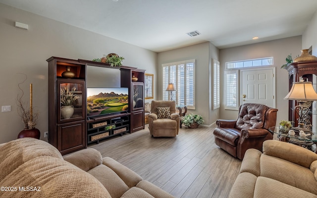5084 W Desert Poppy Ln, Marana, AZ 85658 - living area with baseboards, visible vents, and light wood-type flooring