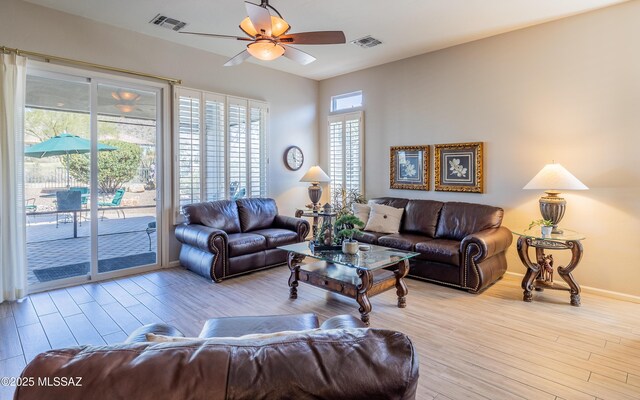 5084 W Desert Poppy Ln, Marana, AZ 85658 - living area featuring baseboards, ceiling fan, visible vents, and light wood-type flooring