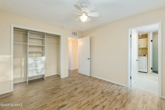 unfurnished bedroom featuring washer / dryer, visible vents, baseboards, light wood-style flooring, and a closet