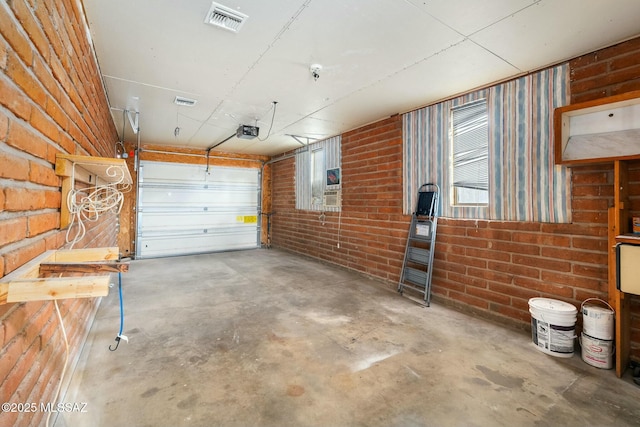 garage with visible vents and a garage door opener