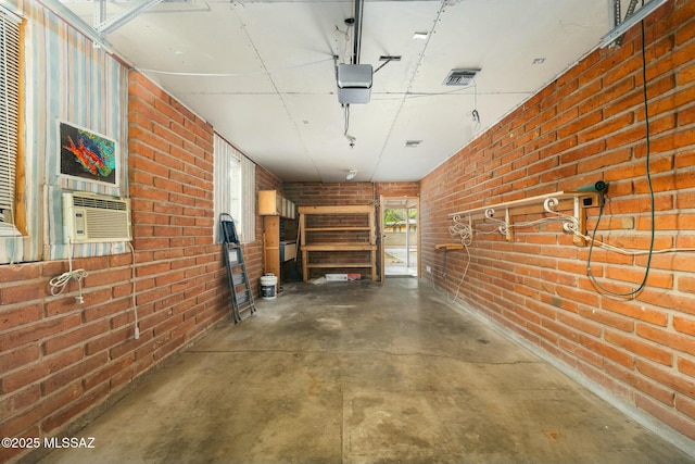 garage with cooling unit, visible vents, and a garage door opener