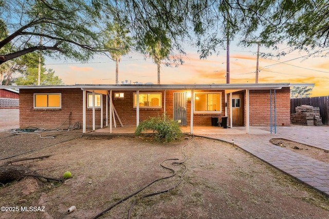 back of property featuring a patio area and fence