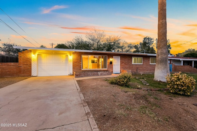 ranch-style home with a garage and driveway