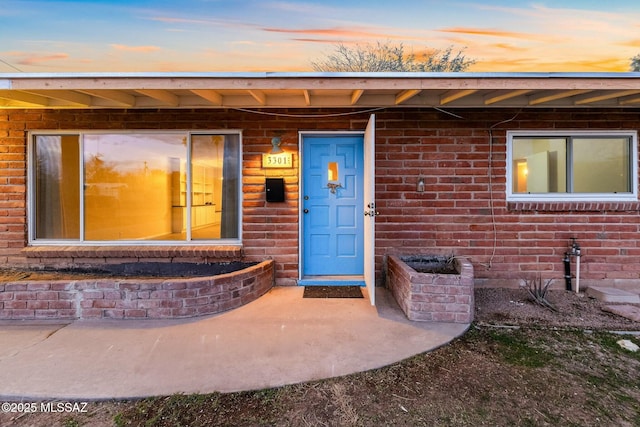 exterior entry at dusk with brick siding