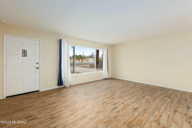 interior space with light wood-style flooring and baseboards