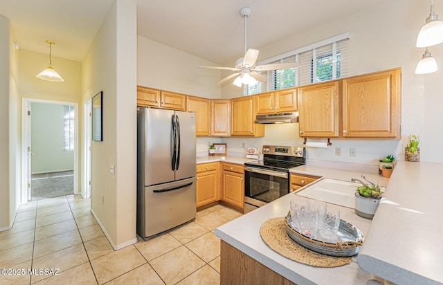 kitchen featuring appliances with stainless steel finishes, light countertops, under cabinet range hood, a sink, and light tile patterned flooring