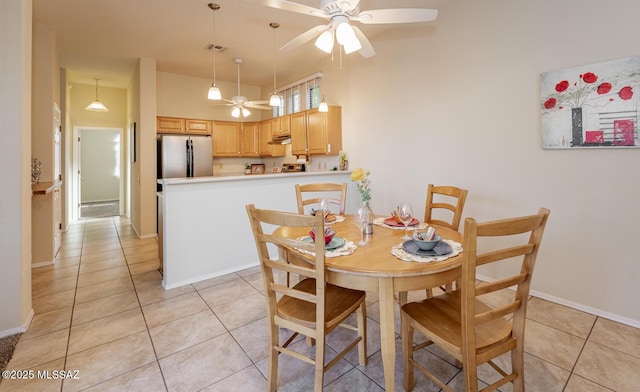 dining space featuring a ceiling fan, visible vents, baseboards, and light tile patterned floors