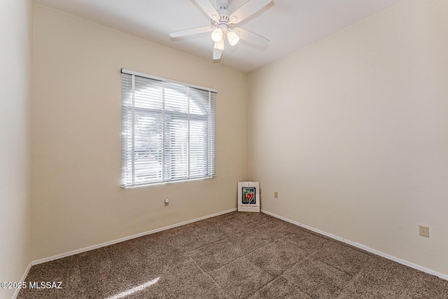 spare room with carpet floors, baseboards, and a ceiling fan